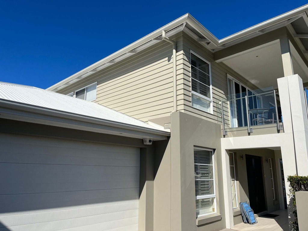 Beige residential house siding and garage detailing in Bulimba